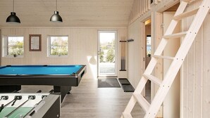 A pool table in a room with wooden walls, a ladder, and two pendant lights. - 14 Person Holiday Home in Vaeggerlose (Vaeggerlose)
