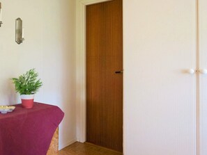 Simple, clean room with a table and potted plant.
