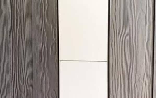 A room with a wooden panel wall and a white central panel. - 5 Star Holiday Home in Sydals (Sydals)