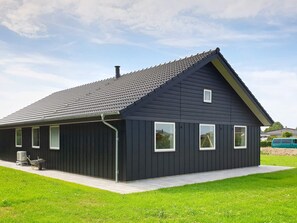 A modern two-story house with a dark exterior, a sloped roof, and a visible chimney. - 5 Star Holiday Home in Sydals (Sydals)