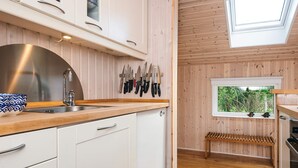 A modern kitchen with white cabinets, a stainless steel sink, and a skylight. - 6 Person Holiday Home in Hadsund (Hadsund)