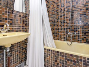 A bathroom with a sink, shower, and tiled walls. - Lovely Holiday Home in Jutland near Beach (Ebeltoft)