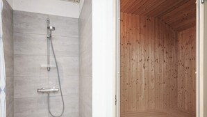 A shower with a handheld showerhead and a wall-mounted faucet. - 4 Star Holiday Home in Oksbol (Oksbol)