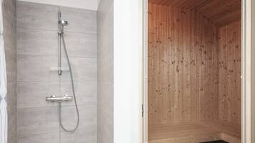 A shower with a handheld showerhead and a wall-mounted faucet.