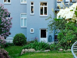 A two-story building with a blue exterior, multiple windows, and a small door. - 4 Person Holiday Home in Sonderborg (Sønderborg)
