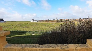 A rural landscape with a white house, open fields, and a clear sky. - 12 Person Holiday Home in Lemvig (Lemvig)