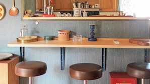 A kitchen with wooden stools, a vintage radio, and a red box labeled 'BRIO DOCKGARDEROB'. - 6 Person Holiday Home in Lidkoping (Lidköping)