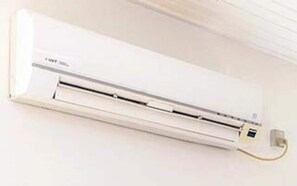 A wall-mounted air conditioner with a control panel and a power cord. - 8 Person Holiday Home in Albaek (Aalbaek)