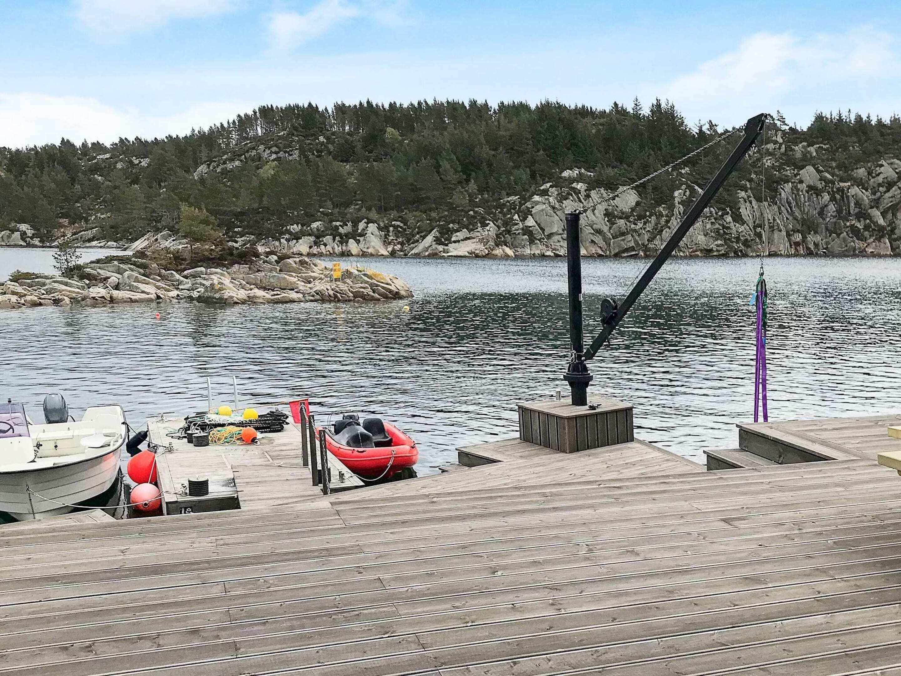 A wooden dock with boats and fishing equipment.