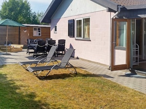 A patio area with outdoor seating and a covered section.