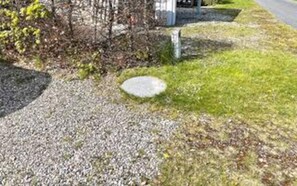 A gravel path leading to a stone structure, surrounded by grass and sparse vegetation. - Tasteful Holiday Home in KarrebÃ¦ksminde near Sea (Karrebæksminde)