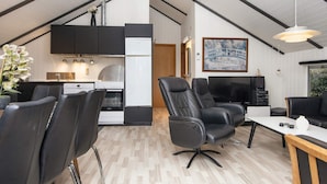 A modern loft-style living space with a kitchen, dining area, and seating. - Scenic Fjord Retreat-by Traum (Vemb)