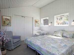 A bedroom with a bed, a chair, a desk, and a wardrobe. - 6 Person Holiday Home in Lokken (Lokken)