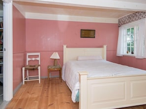 A bedroom with a single bed, a chair, a small table with a lamp, and a window with curtains. - 6 Person Holiday Home in Fano (Fano)