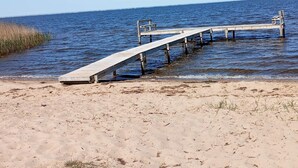 A wooden pier extending into calm waters, with a sandy beach in the foreground. - Vibrant Holiday Home in Tarm near Sea (Hemmet)