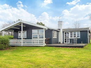A two-story house with a covered porch and a separate garage. - Vibrant Holiday Home in Jutland near Sea (Glesborg)