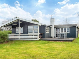 A two-story house with a covered porch and a separate garage.