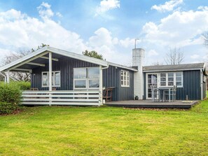 A two-story house with a porch and a deck. - Vibrant Holiday Home in Jutland near Sea (Glesborg)