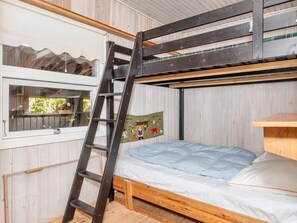 A bunk bed with a ladder, a window with a view, and a wall-mounted decoration. - 8 Person Holiday Home in Thyholm (Thyholm)