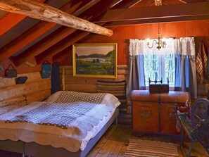 A rustic wooden room with a bed, a dresser, a painting, and a window with curtains. - Vintage Charm by the Sea-by Traum (Surnadal)