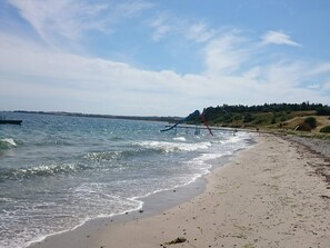 A beach with a water slide and a sandy shore. - 8 Person Holiday Home in Knebel (Knebel)