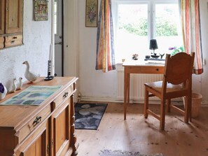 A wooden desk with a lamp, a chair, and a window with curtains. - 10 Person Holiday Home in Hammenhog (Hammenhög)
