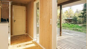 A wooden interior hallway leading to a deck with a view of the outdoors. - 8 Person Holiday Home in Frederiksvaerk (Frederiksvaerk)