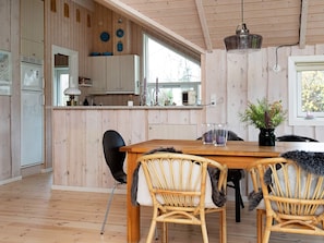 Enjoy meals in the dining area with a wooden table and two chairs.
