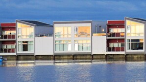 A row of modern, multi-story buildings with large windows, likely a hotel or residential complex. - 4 Person Holiday Home in Sula (Frøya)
