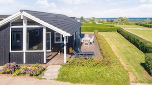 A modern house with a deck, large windows, and a view of the sea. - Alluring Holiday Home in Haderslev near Sea (Hejls)