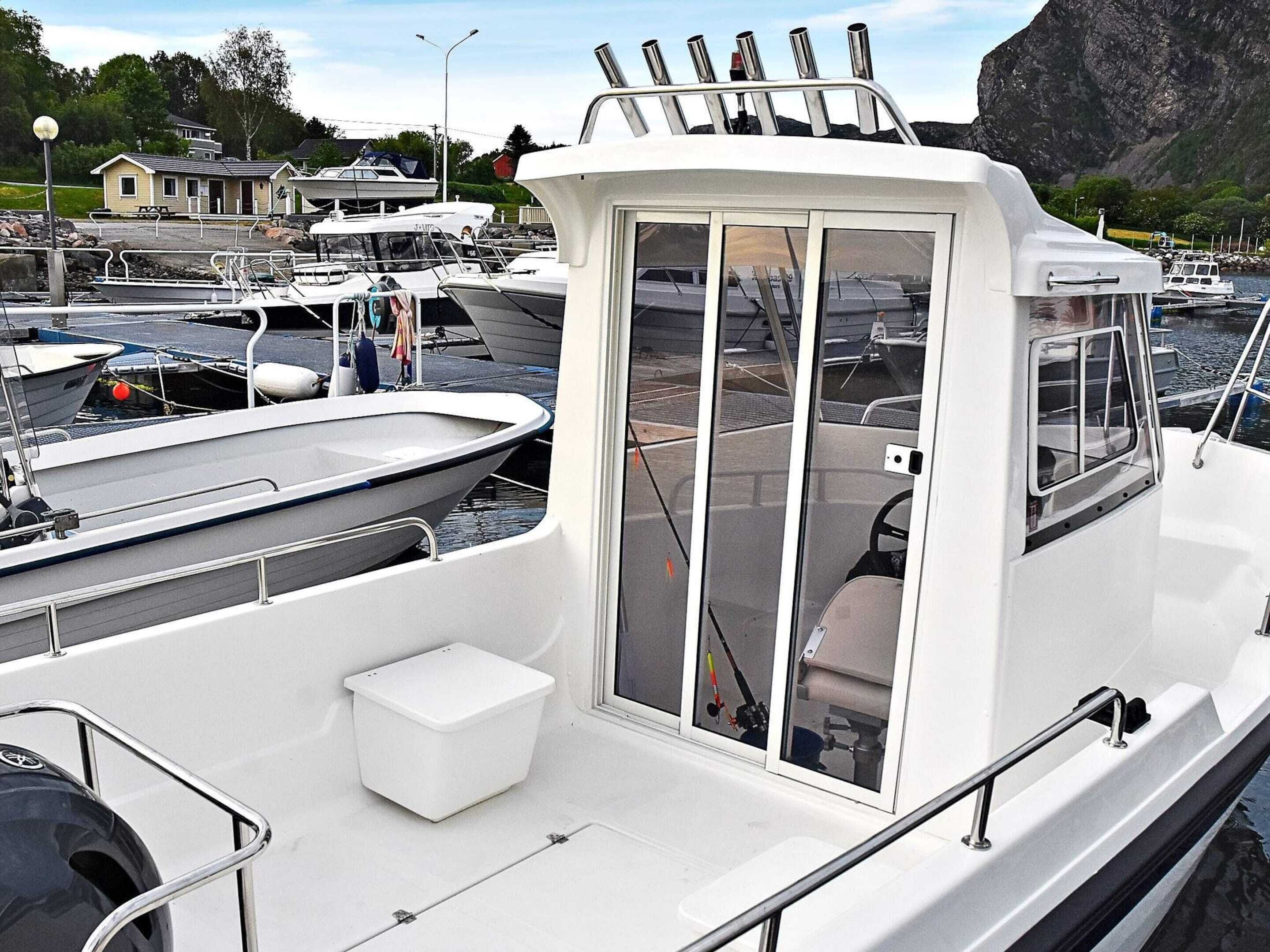 Un bateau doté d’une cabine, d’un petit espace sur le pont et d’un moteur à l’arrière.