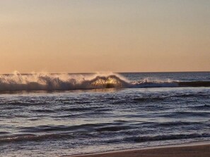 A beach with waves and a clear sky. - 5 Star Holiday Home in Ringkobing (Ringkobing)