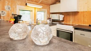 A kitchen with wooden walls, a countertop, and a window. - 5 Person Holiday Home in Otterup (Otterup)