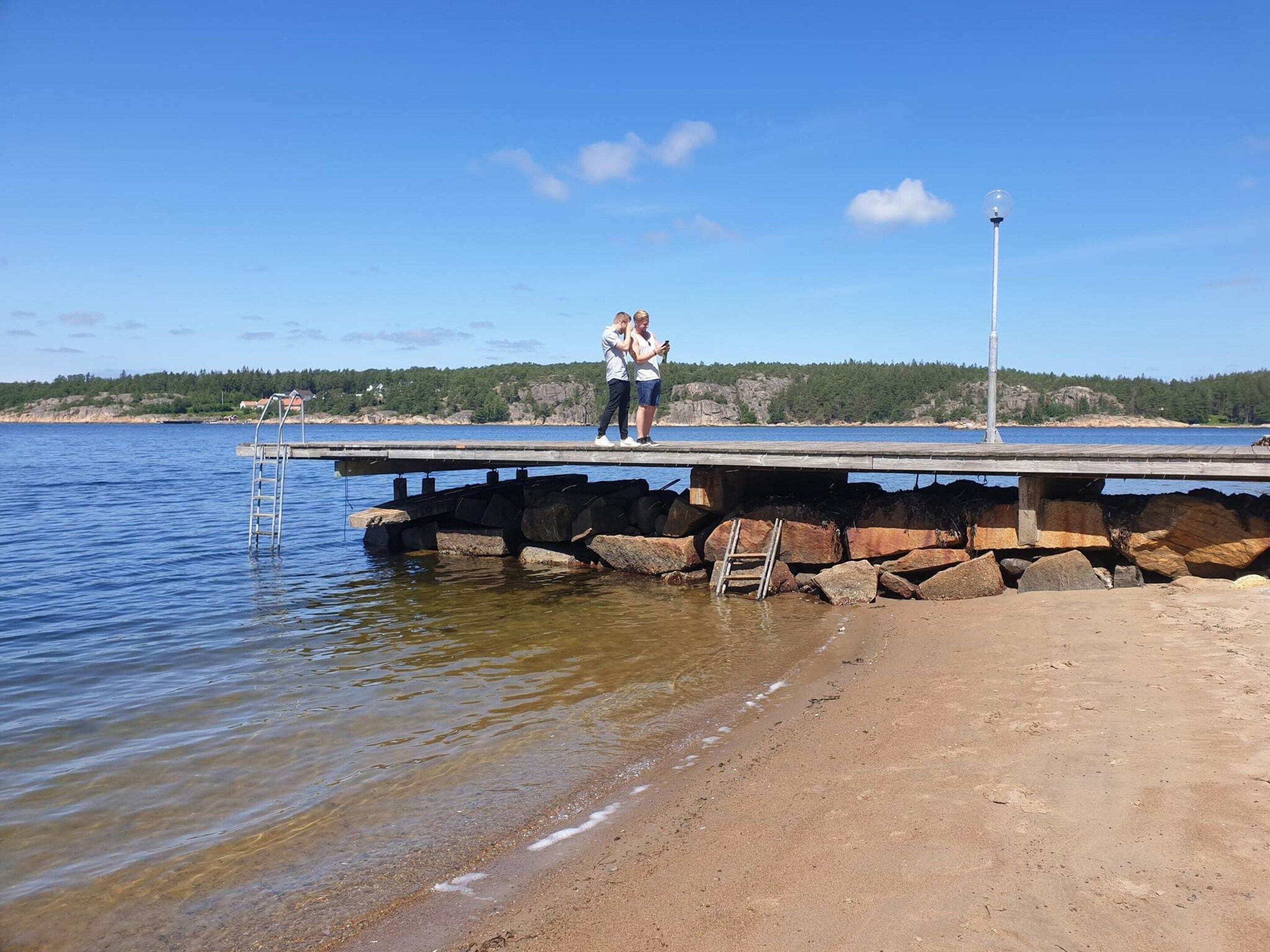 Un muelle que se adentra en una masa de agua bajo un cielo despejado.