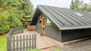 A small building with a sloped roof, a wooden door, and a window. - 6 Person Holiday Home in Farvang (Farvang)
