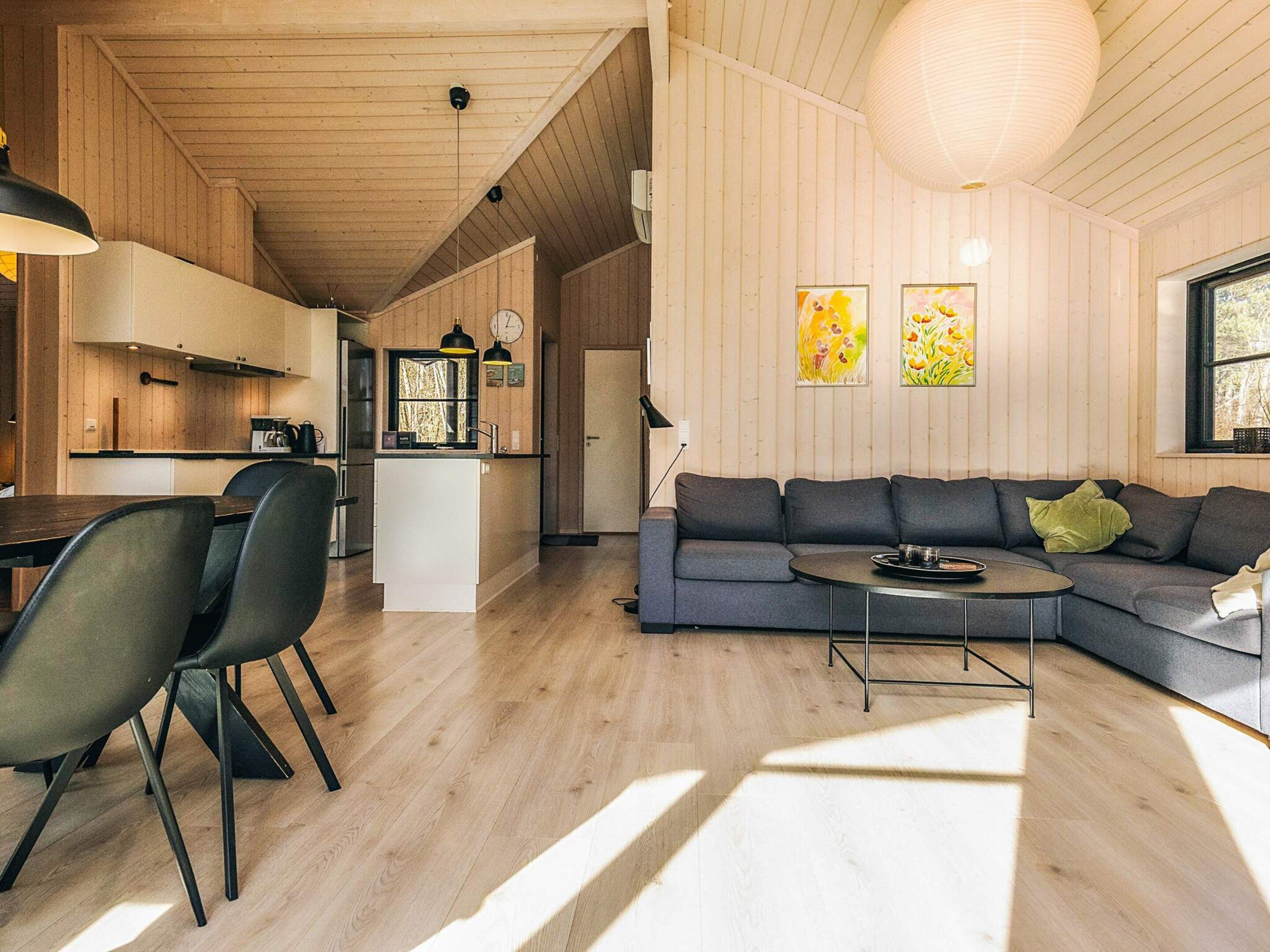 A modern interior with a dining area, kitchen, and living space.