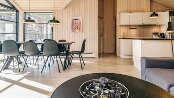 En modern inredning med matplats, kök och sittgrupp.