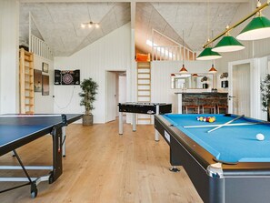 A recreational room with a ping pong table, foosball table, and a pool table. - 5 Star Holiday Home in Grenaa (Grenaa)