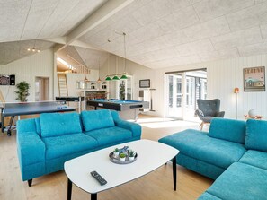A spacious living area with a pool table, blue sofas, and a billiards table. - 5 Star Holiday Home in Grenaa (Grenaa)