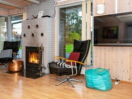 A modern living room with a fireplace, a television, and a cozy seating area.