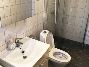 A bathroom with a sink, toilet, and shower. - 6 Person Holiday Home in Seim (Alver)