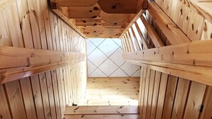 A wooden staircase with a tiled floor leading to a higher level.