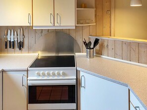 A kitchen with a stove, oven, and knife rack. - 4 Star Holiday Home in Nordborg (Nordborg)