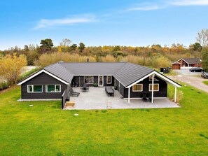 A modern two-story house with a covered patio, a garage, and a driveway. - Holiday Home in Idestrup (Idestrup)
