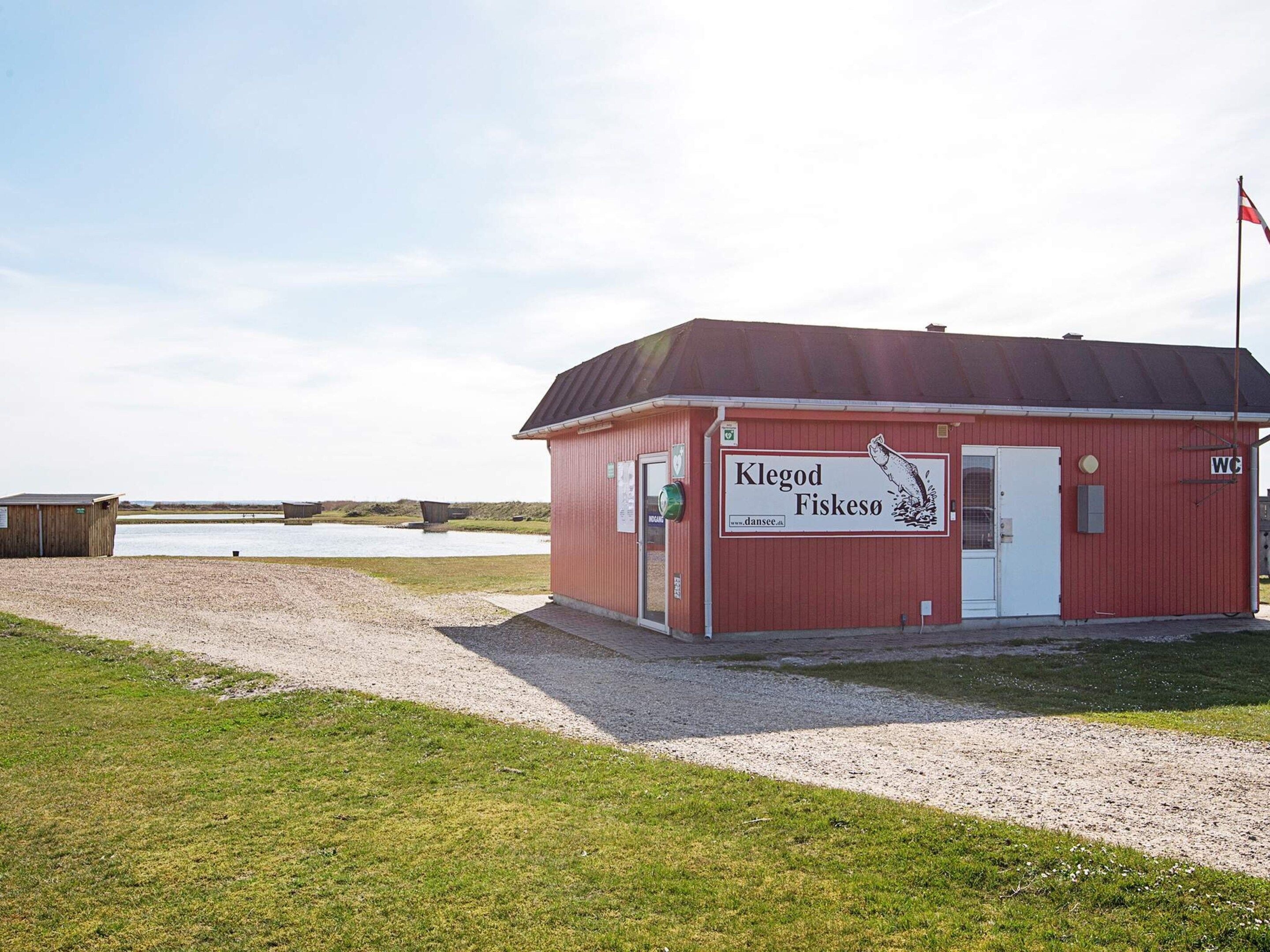 A red building with a sign reading 'Klegod Fiskeso' and a flag on top.