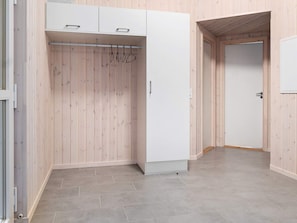 A room with a wardrobe, a coat rack, and a door. - Holiday Home in Kappeln (Kappeln)