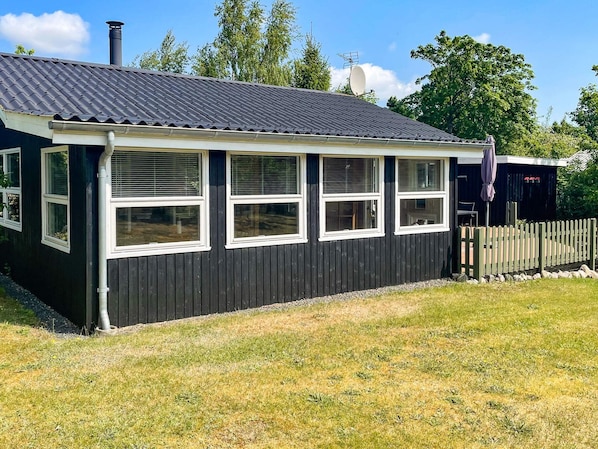 A black building with a sloped roof and multiple windows. - Lovely Holiday Home in Jutland near Sea (Hals)