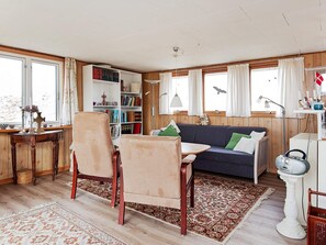 A cozy living room with a sofa, chairs, a bookshelf, and a table. - Enticing Holiday Home in FanÃ¸ near Sea (Fano)