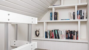 A white bookshelf with multiple shelves filled with books. - Holiday Home in Hurup Thy (Hurup Thy)