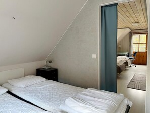 A bedroom with a bed, a nightstand, a desk, and a chair. - 4 Person Holiday Home in Hemse (Hemse)